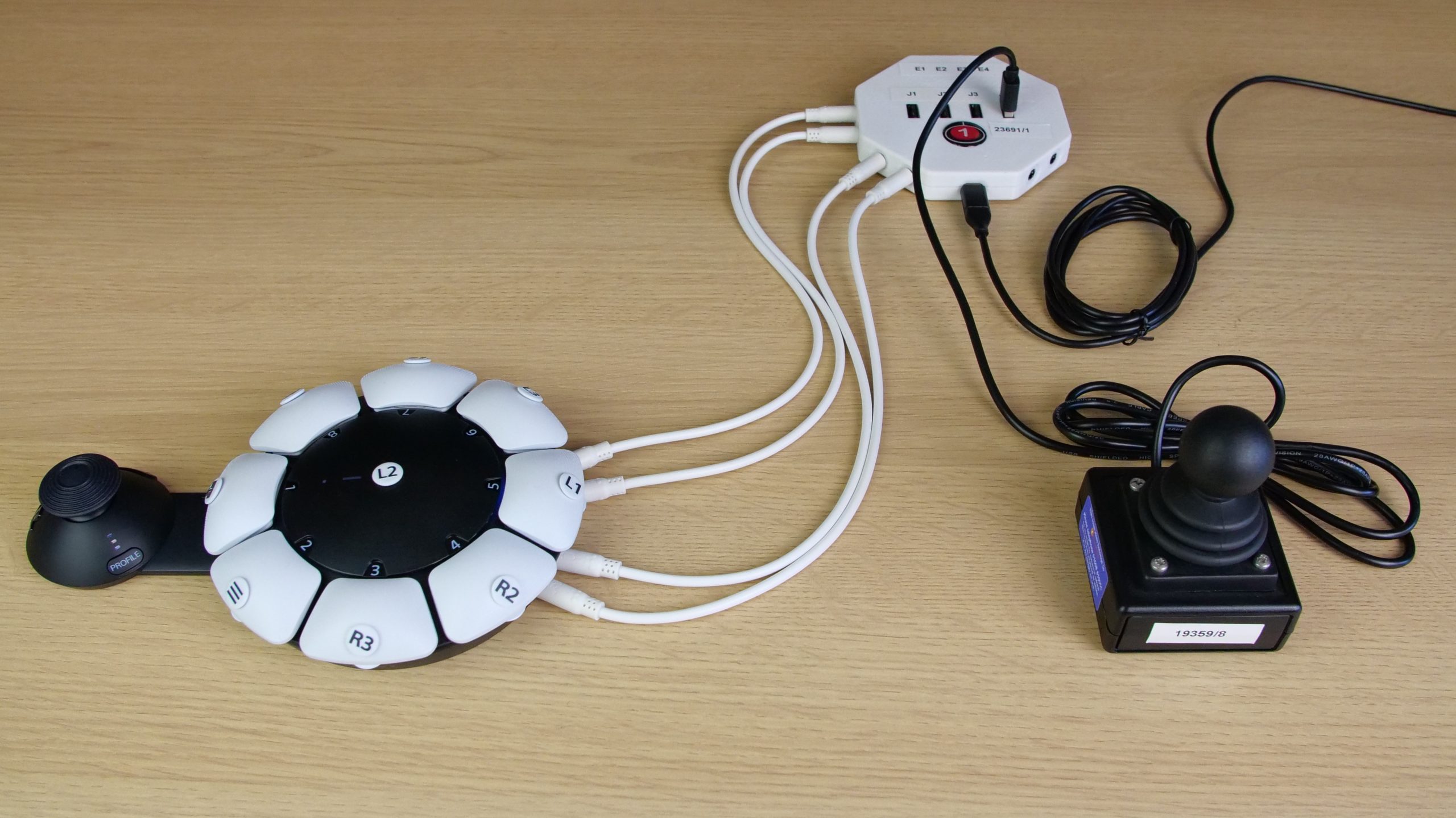 A photo of a OneSwitch Zik-Zak mini joystick connected via USB to a HiD Remapper v7 and four 3.5mm patch leads connected to an Access controller.