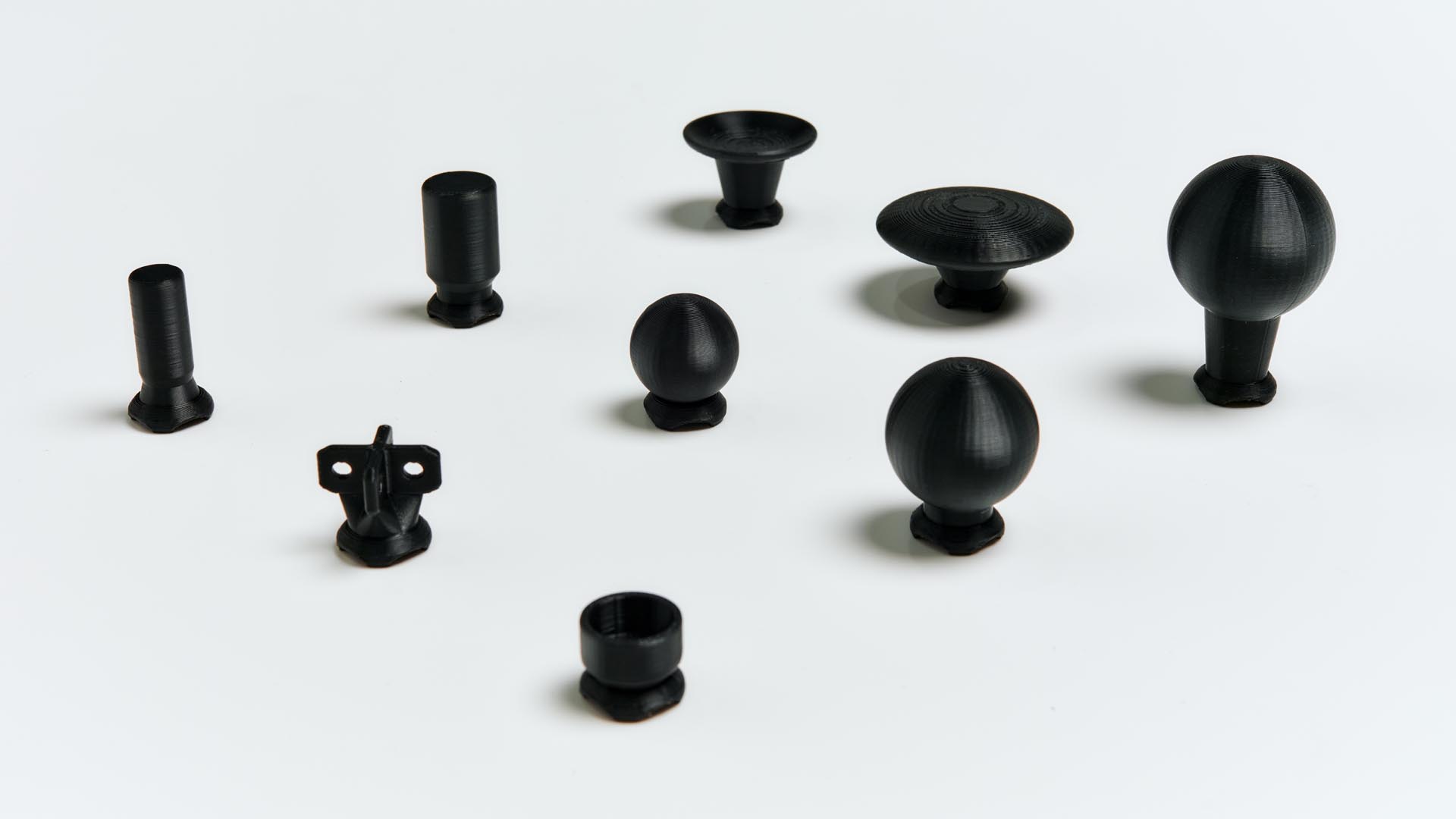 Photo showing a range of 3D printed joystick toppers.