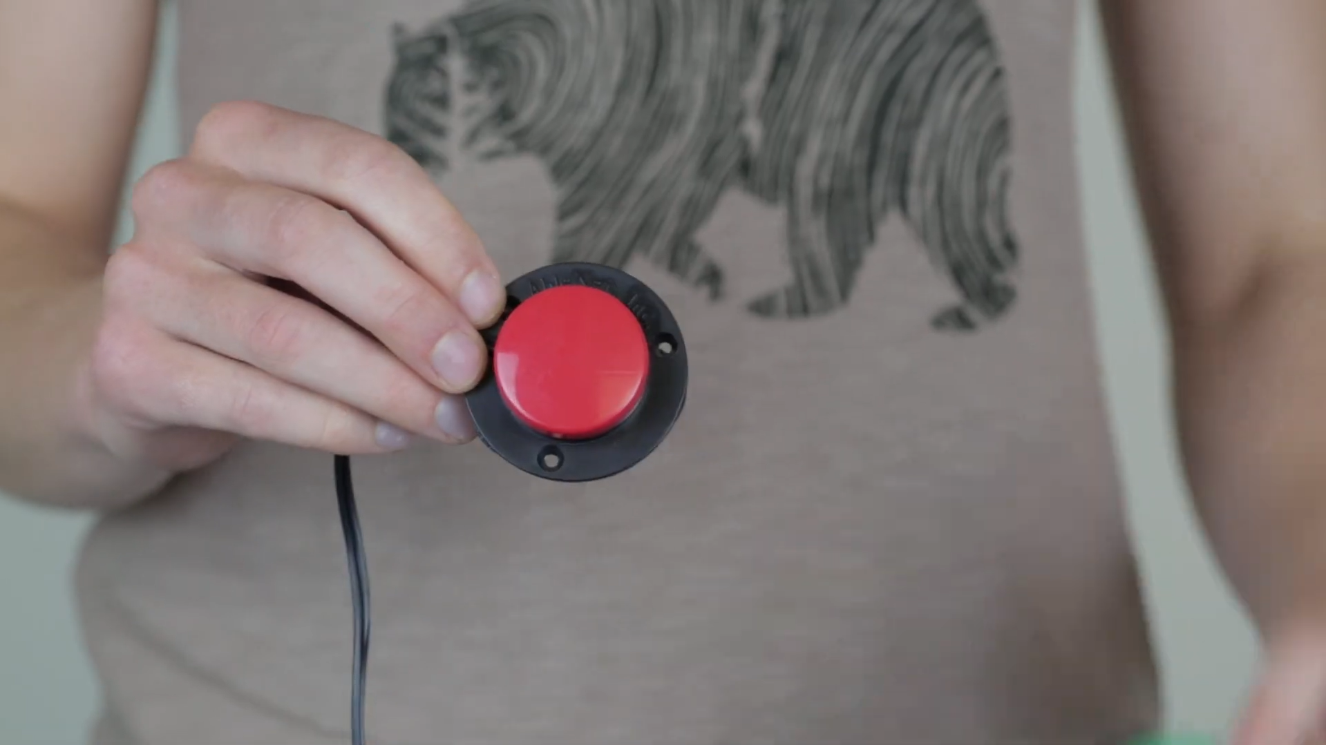 A red AbleNet Specs switch being held.